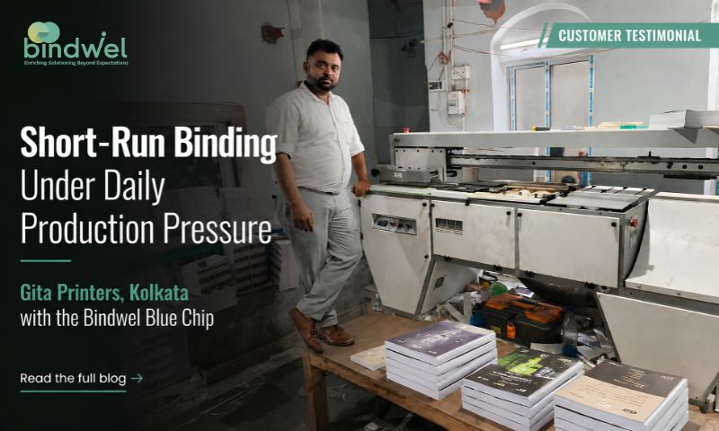 Gita Printers operating a soft cover book binding machine for short-run publishing and commercial print work.